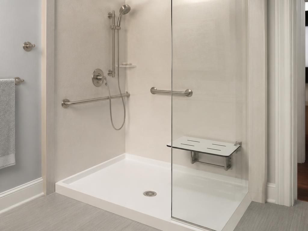 Walk-in shower with built-in bench seat and glass enclosure